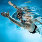 Professional swimmer wearing Speedo swimwear | underwater photog