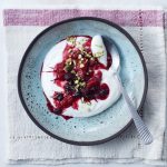 Warm mixed berries with yoghurt and pistachio nuts