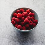 Fresh raspberries in a blue bowl
