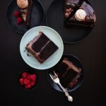 Chocolate ganache layer cake slices on dark background