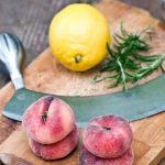 peaches-lemon-and-rosemary-on-a-cutting-board