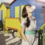 Woman blowing bubble gum outdoors