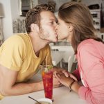 Young couple kissing in kitchen